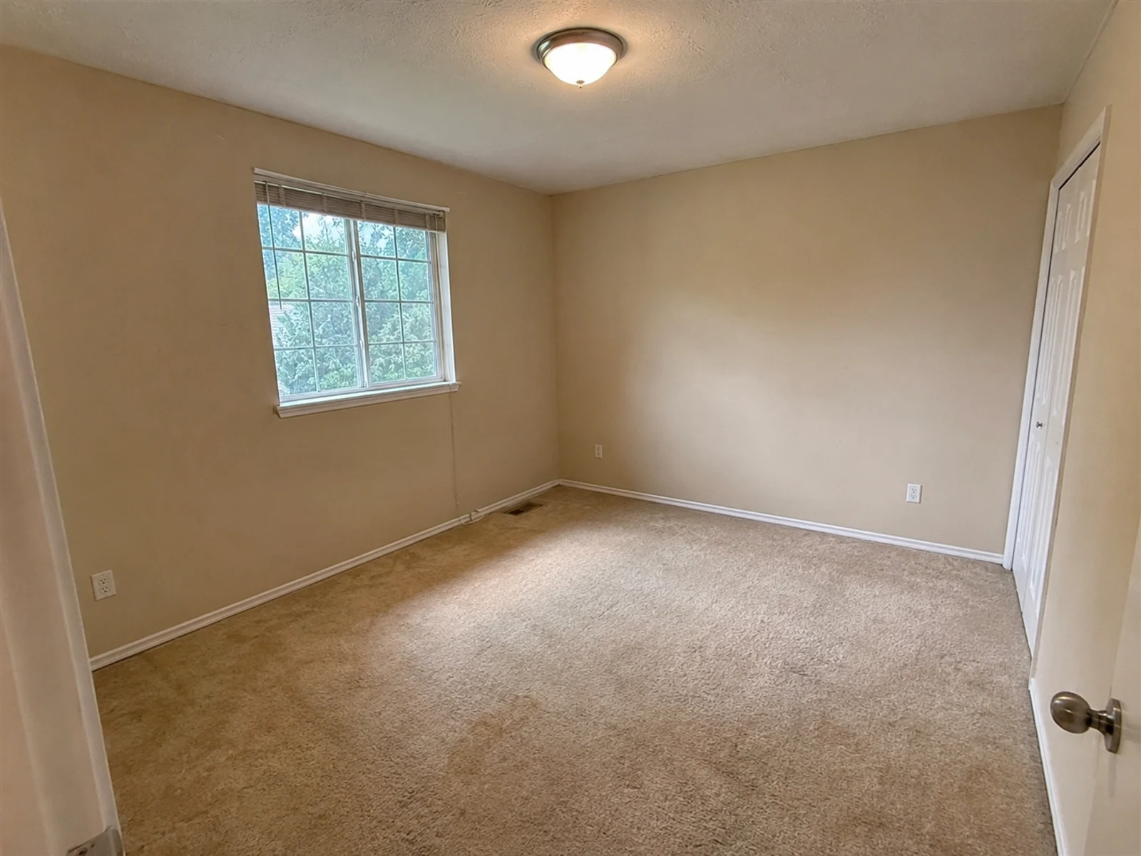 Empty secondary bedroom before AI warm neutral bedroom concept