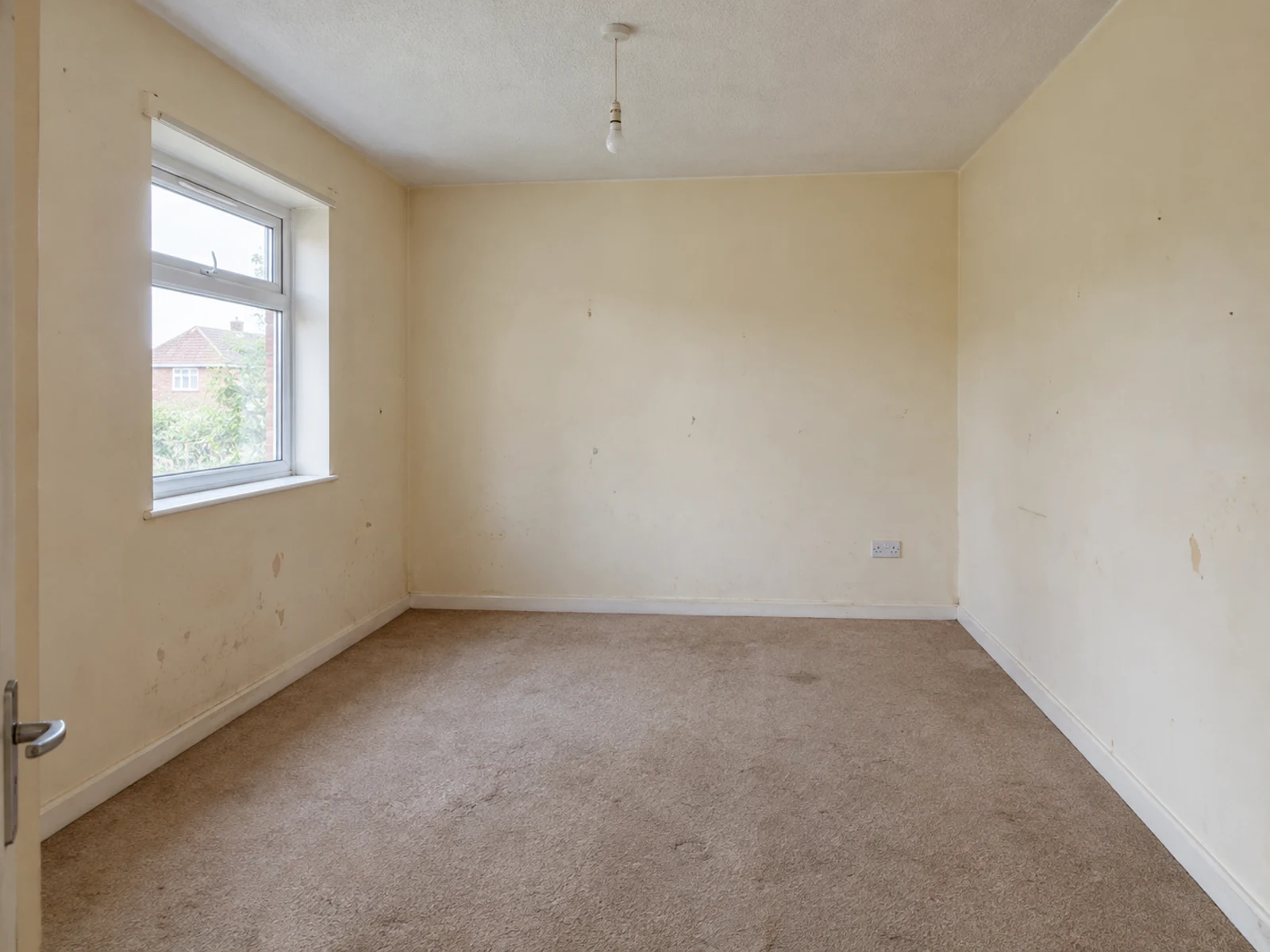 Empty spare room with a left-wall window before AI home office design