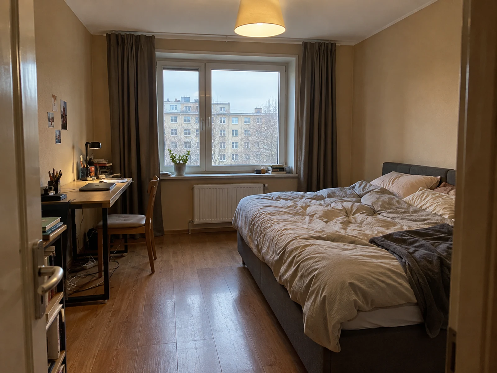 Bedroom with a small left-wall desk and existing bed before AI design