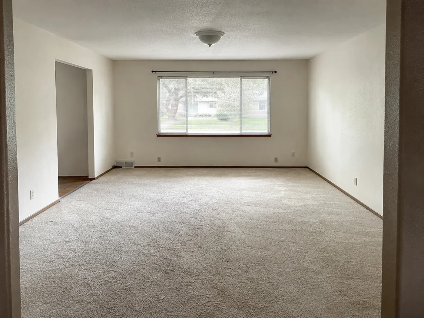 Empty living room before AI sofa layout and TV wall concept